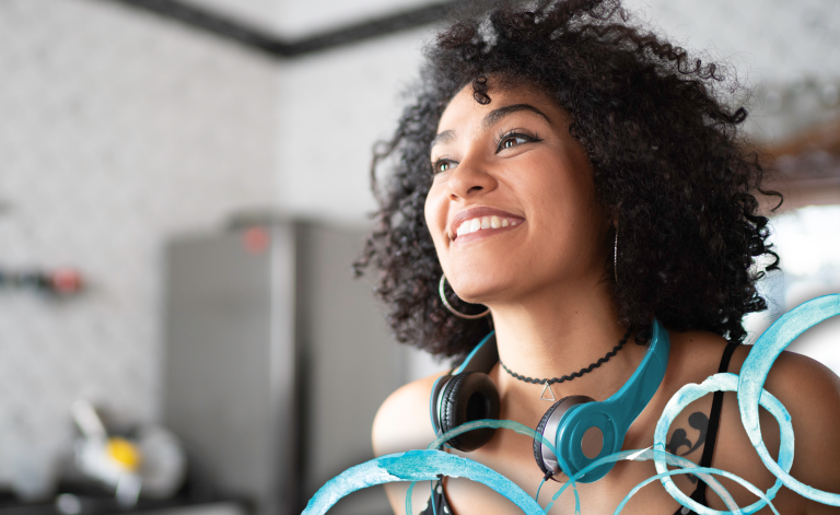 woman smiling with headphones on her head