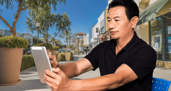 Guy outside, writing on his tablet